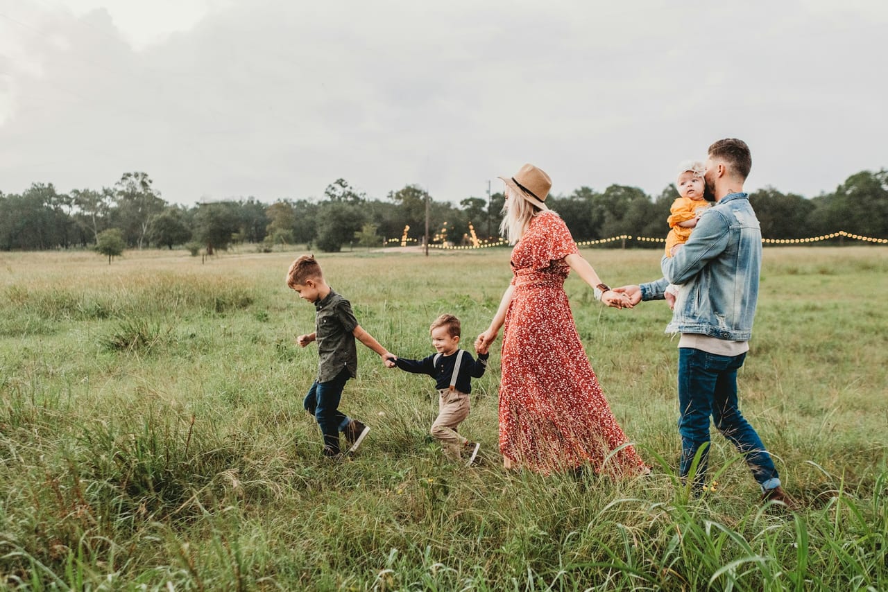 A family walking together outdoors on a summer afternoon
