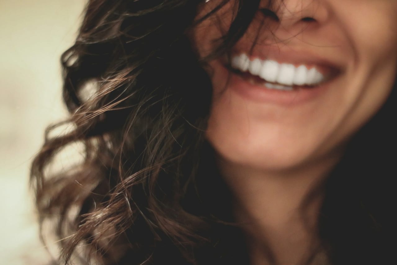 A patient smiling confidently after professional teeth whitening